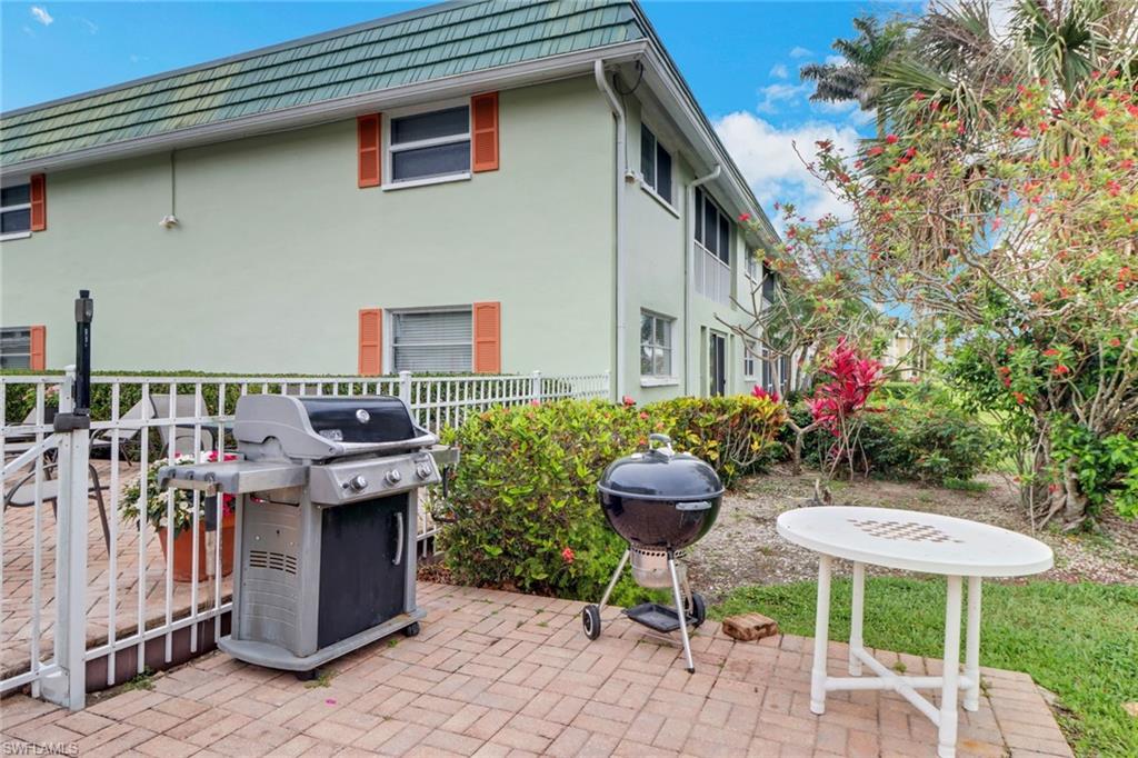 300 Valley Stream Drive, Unit A4 Naples, FL 34113 - Photo 25 of 25 a view of a patio with table and chairs and potted plants