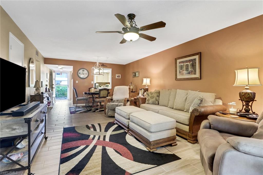 300 Valley Stream Drive, Unit A4 Naples, FL 34113 - Photo 6 of 25 a living room with furniture a ceiling fan and a flat screen tv
