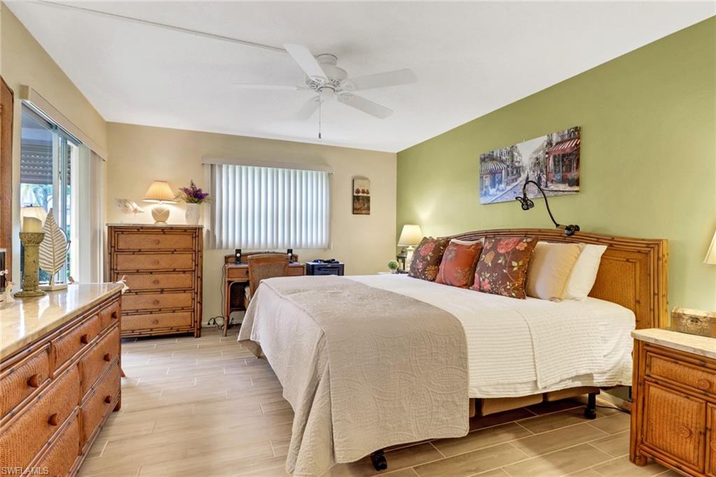 300 Valley Stream Drive, Unit A4 Naples, FL 34113 - Photo 8 of 25 a bedroom with a bed and a cabinets