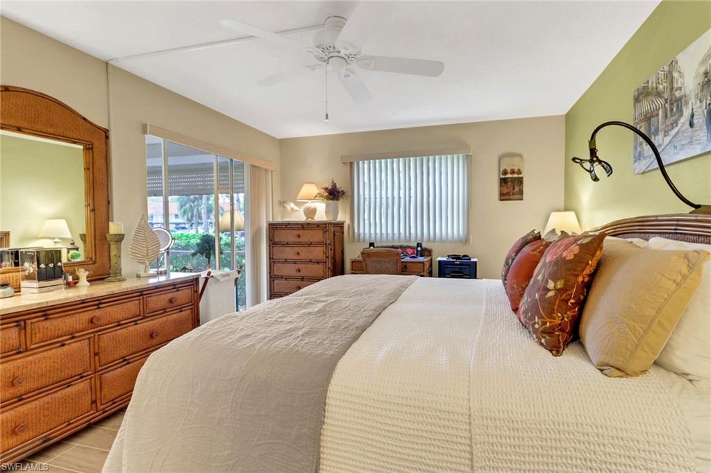 300 Valley Stream Drive, Unit A4 Naples, FL 34113 - Photo 9 of 25 a bedroom with a large bed and wooden floor