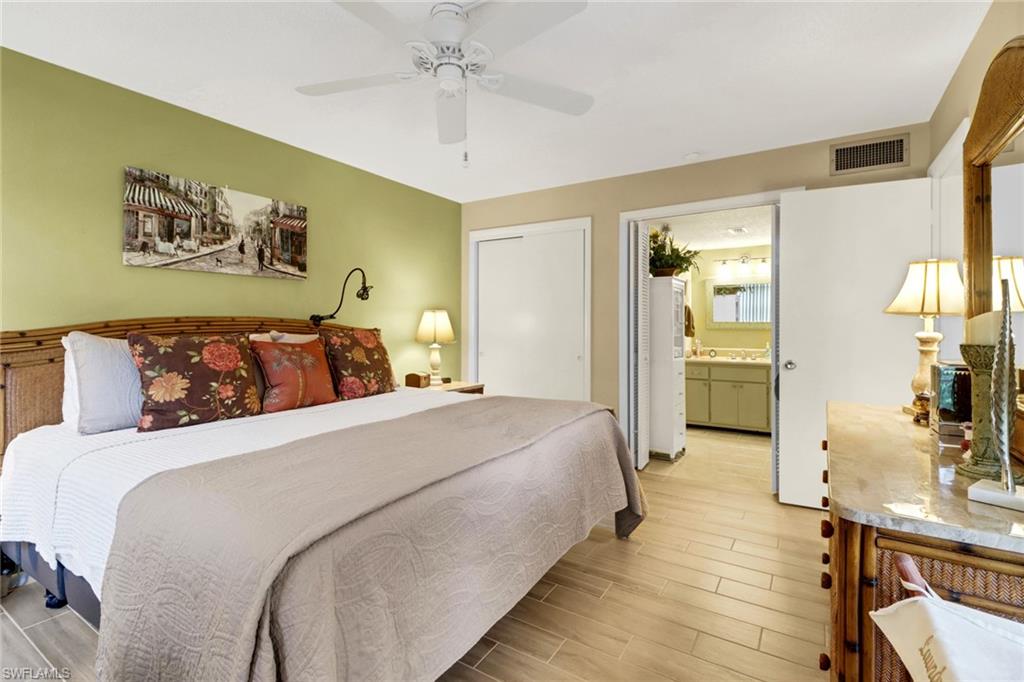 300 Valley Stream Drive, Unit A4 Naples, FL 34113 - Photo 10 of 25 a bedroom with bed and wooden floor