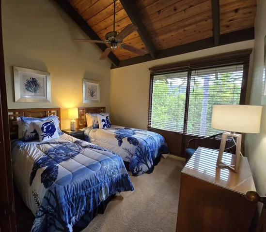 a bathroom with a granite countertop sink a toilet a mirror and shower