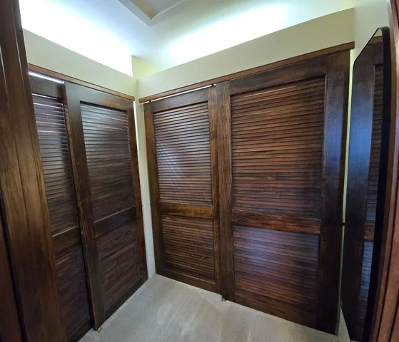 a bedroom with two beds and a window