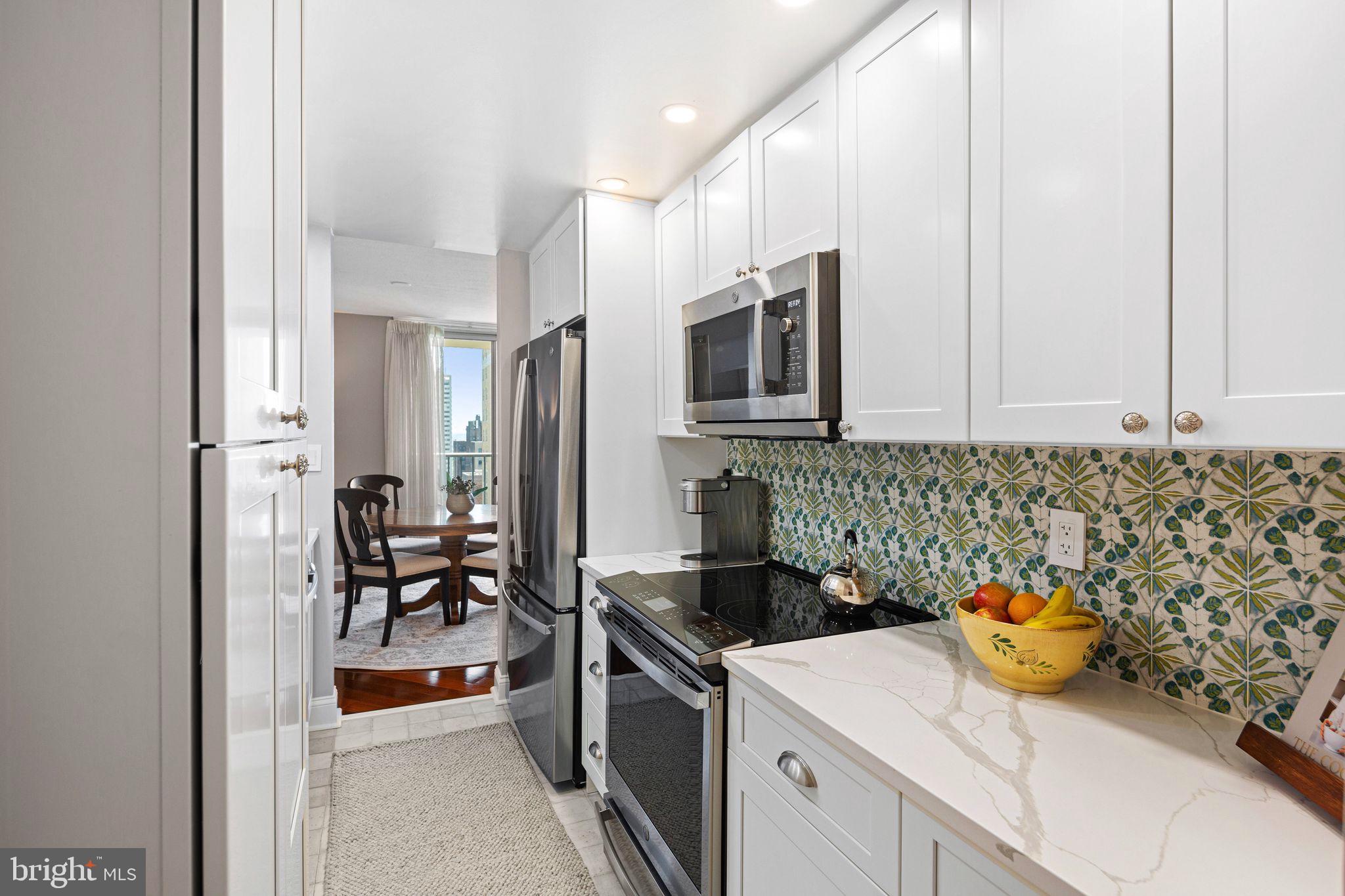 1919 Chestnut Street, Unit 2016 Philadelphia, PA 19103 - Photo 13 of 34 a kitchen with stainless steel appliances a stove a sink and a refrigerator