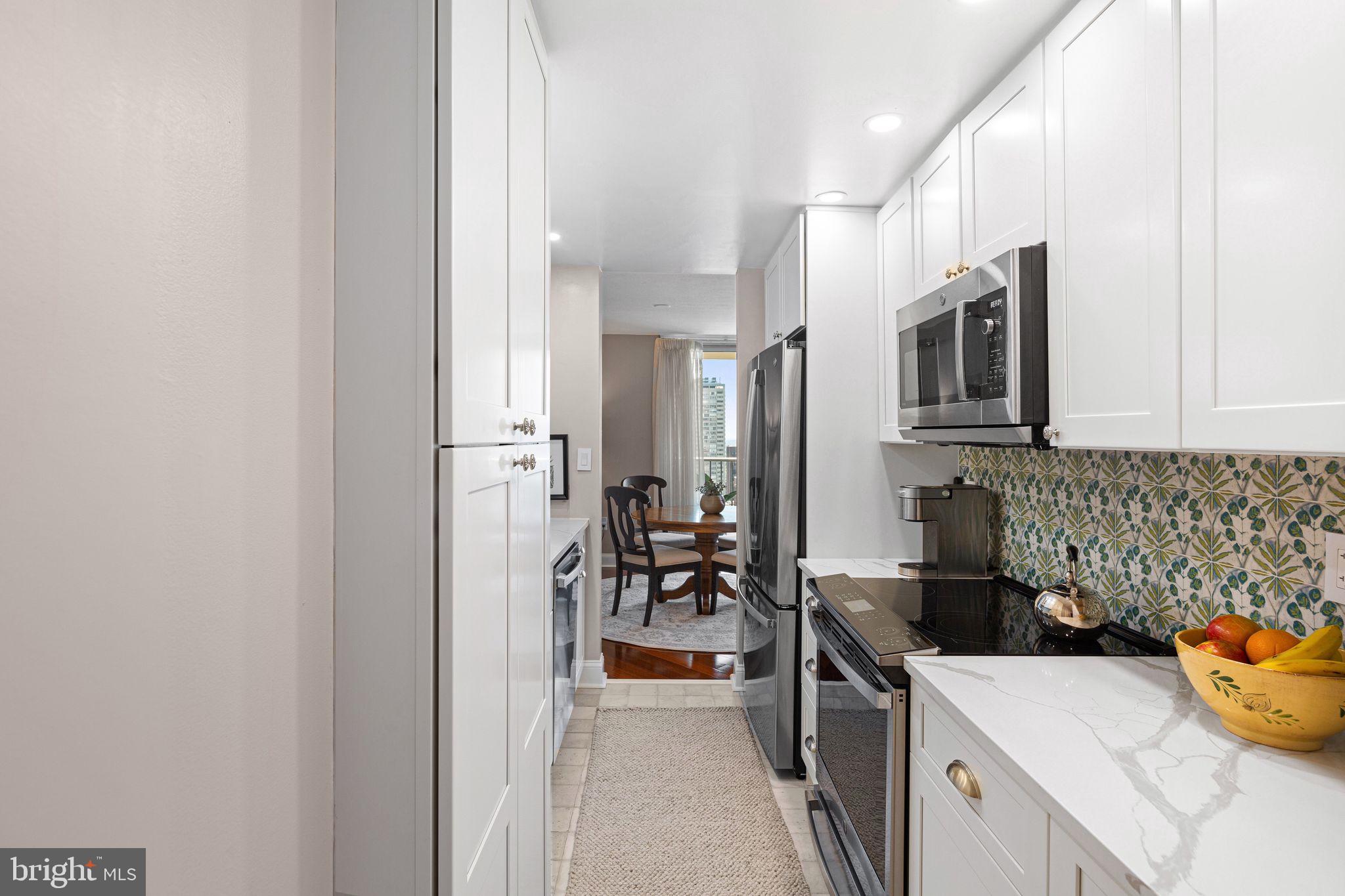 1919 Chestnut Street, Unit 2016 Philadelphia, PA 19103 - Photo 14 of 34 a kitchen with stainless steel appliances a stove a sink and a refrigerator