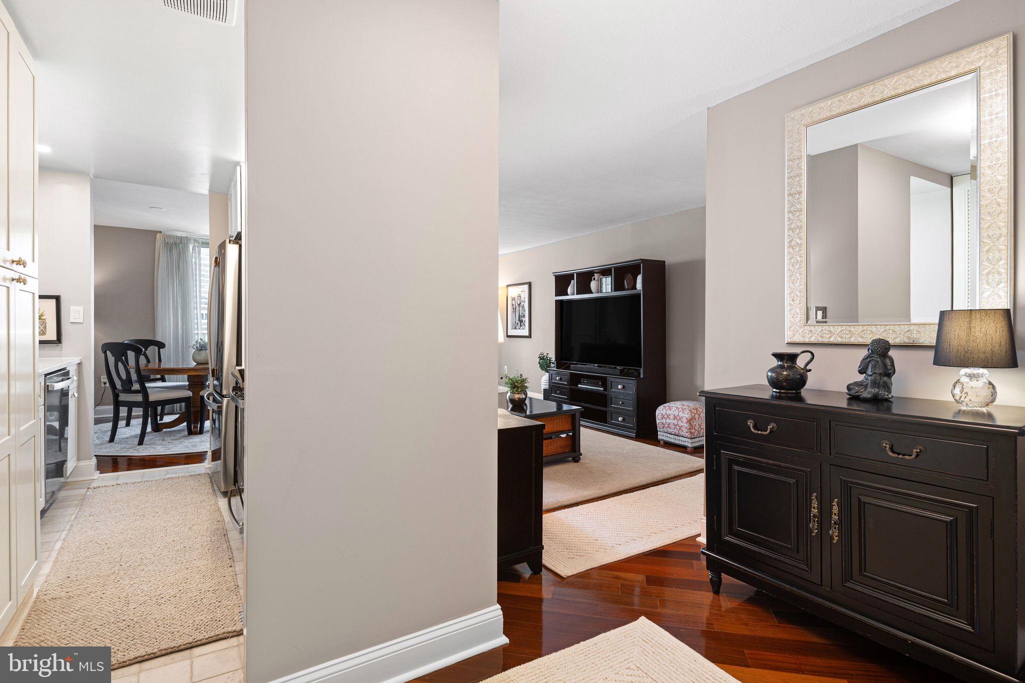1919 Chestnut Street, Unit 2016 Philadelphia, PA 19103 - Photo 2 of 34 a living room with furniture a flat screen tv and a refrigerator