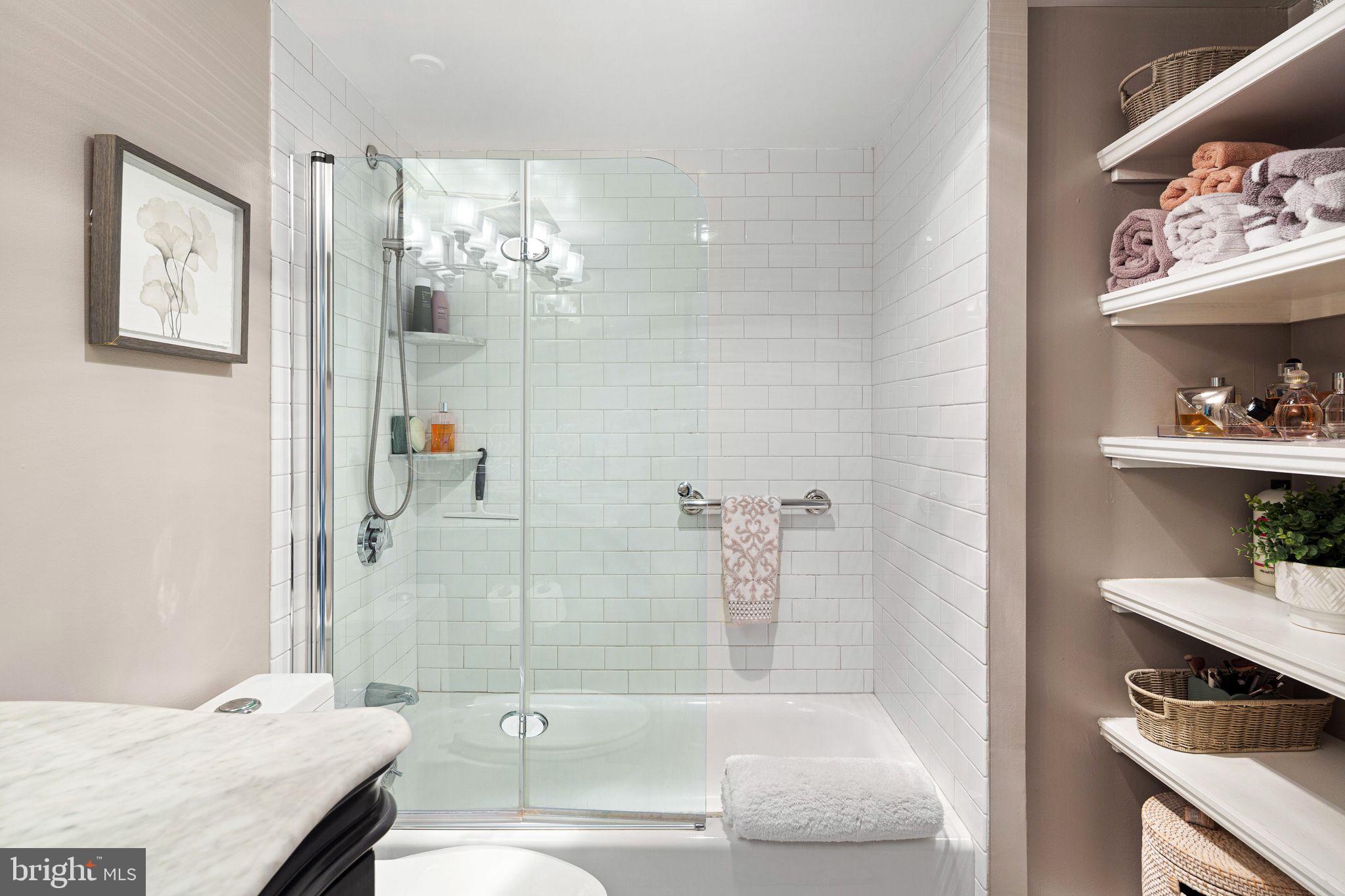 1919 Chestnut Street, Unit 2016 Philadelphia, PA 19103 - Photo 28 of 34 a bathroom with a tub sink and mirror