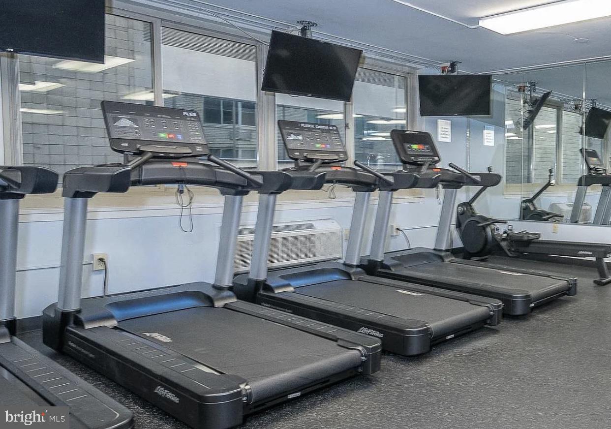 1919 Chestnut Street, Unit 2016 Philadelphia, PA 19103 - Photo 32 of 34 a room with gym equipment and a flat screen tv