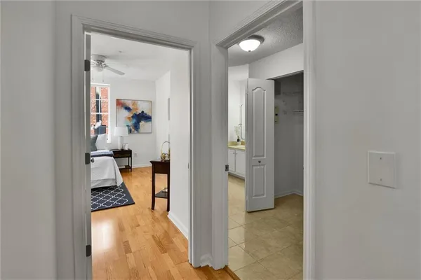 a view of a hallway with wooden floor and a living room