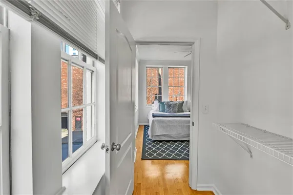 a view of walk in closet with wooden floor