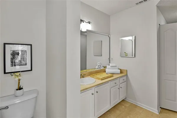 a bathroom with a sink vanity granite and a mirror