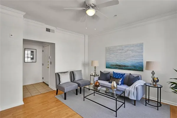 a living room with furniture and wooden floor