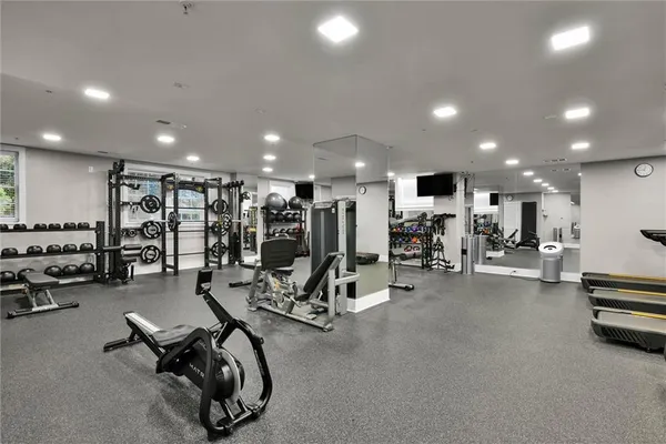 a view of a room with gym equipment and gym equipment