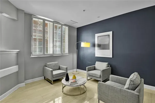 a blue chair sitting in front of a window