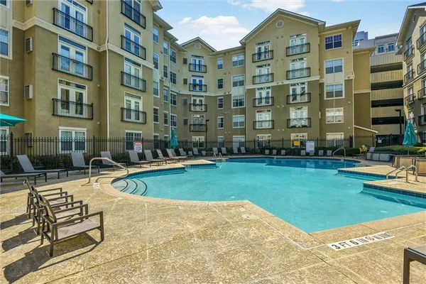 a swimming pool view with a outdoor seating