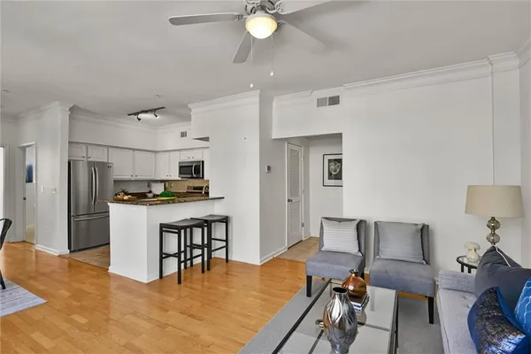a living room with furniture and kitchen view