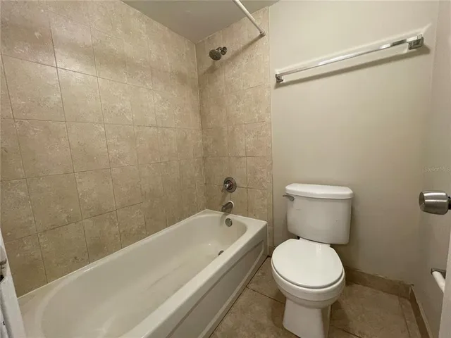 a bathroom with a toilet and a bathtub