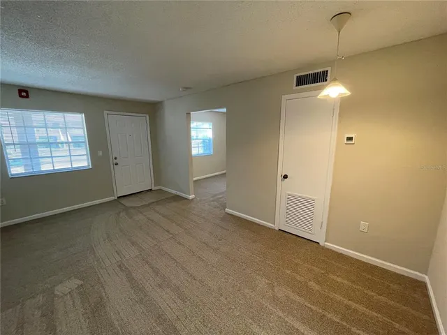 an empty room with windows and entrance