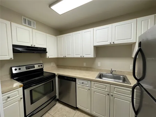 a kitchen with a sink and cabinets