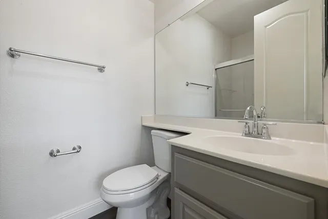 a view of a big room with wooden floor and windows