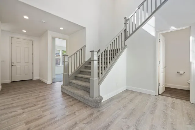 a view of a room with wooden floor chandelier and closet