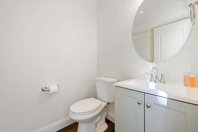 a view of a chandelier fan and wooden floor