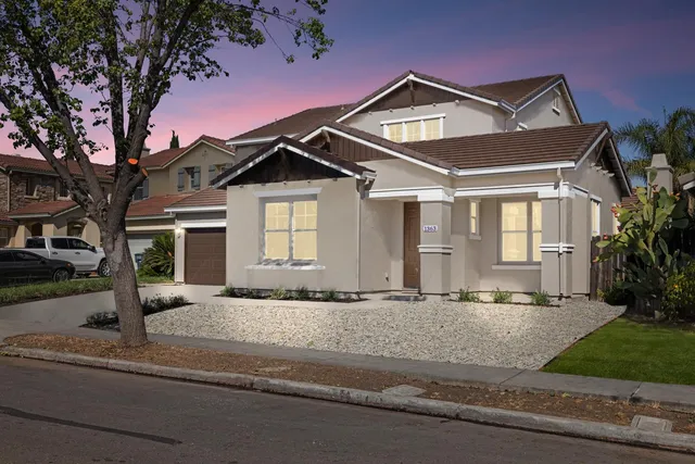 a front view of a house with a garden