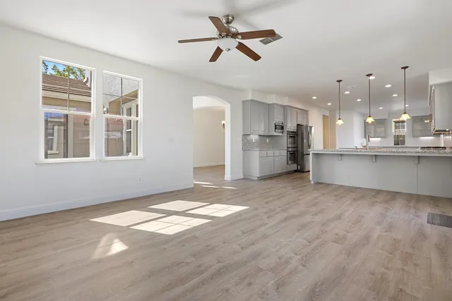a kitchen with granite countertop white cabinets and white stainless steel appliances