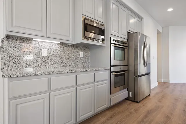 a view of cabinets and wooden floor