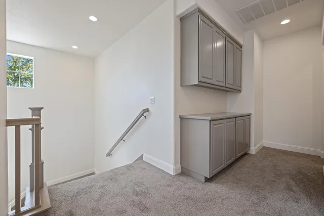 an empty room with a ceiling fan and wooden floor
