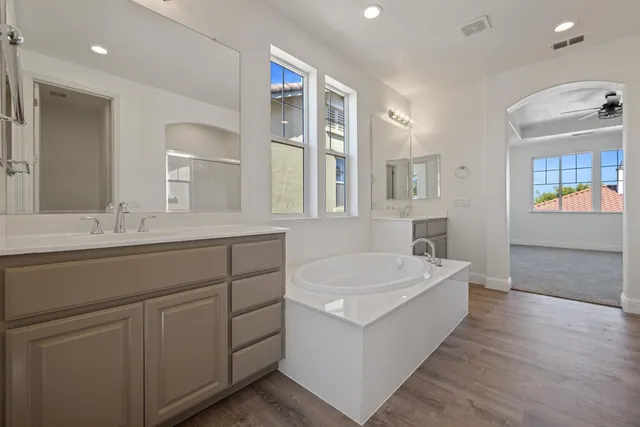 a bathroom with a double vanity sink and a mirror