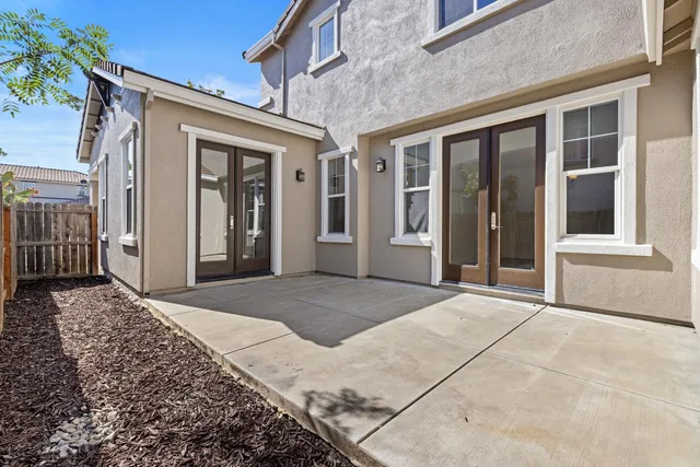 a view of a house with backyard and sitting area