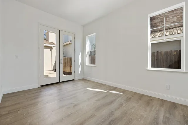 wooden floor in an empty room with a window