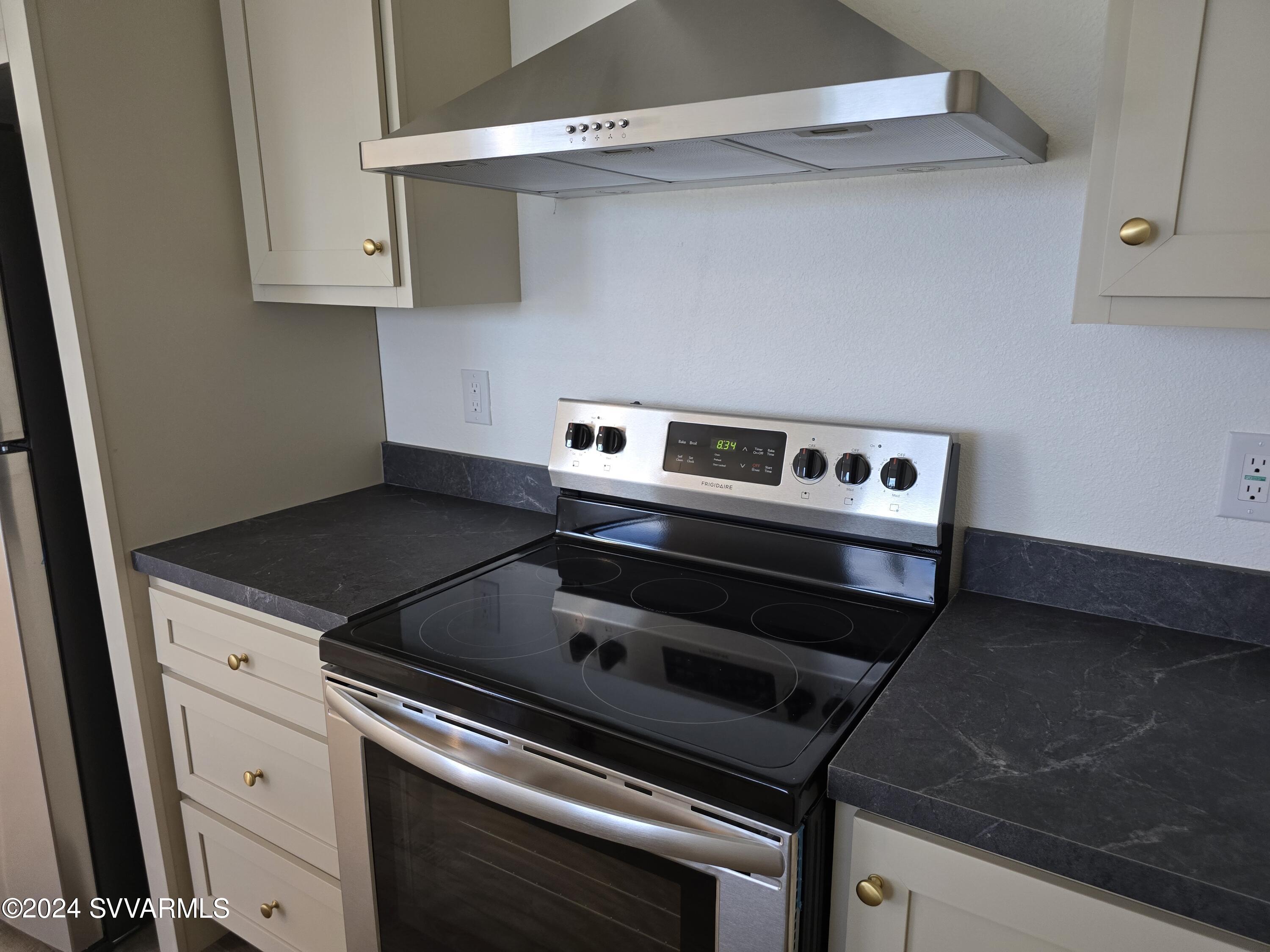 5205 Albatross Road Rimrock, AZ 86335 - Photo 12 of 23 a stove top oven sitting inside of a kitchen