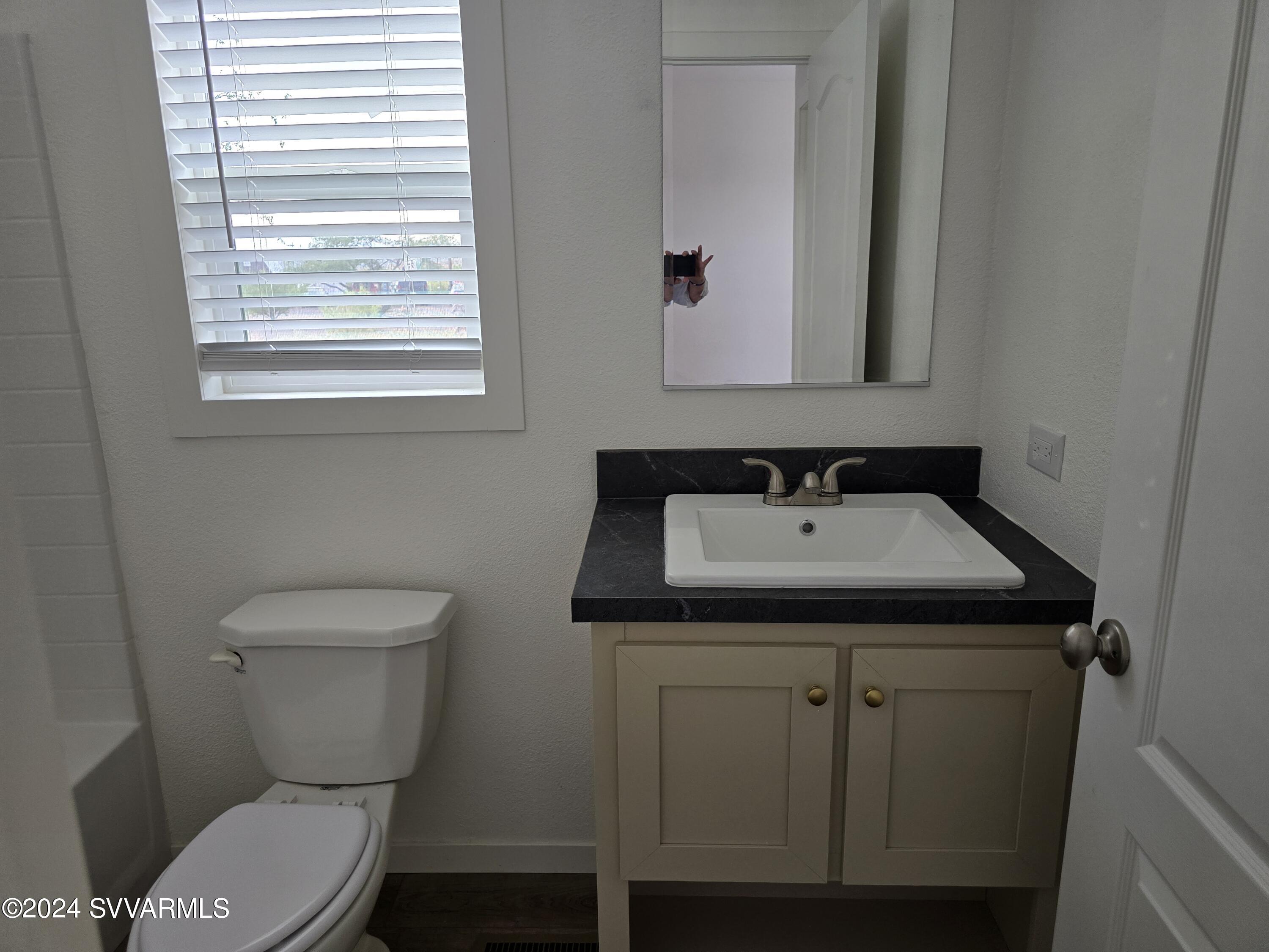 5205 Albatross Road Rimrock, AZ 86335 - Photo 13 of 23 a bathroom with a sink toilet and mirror