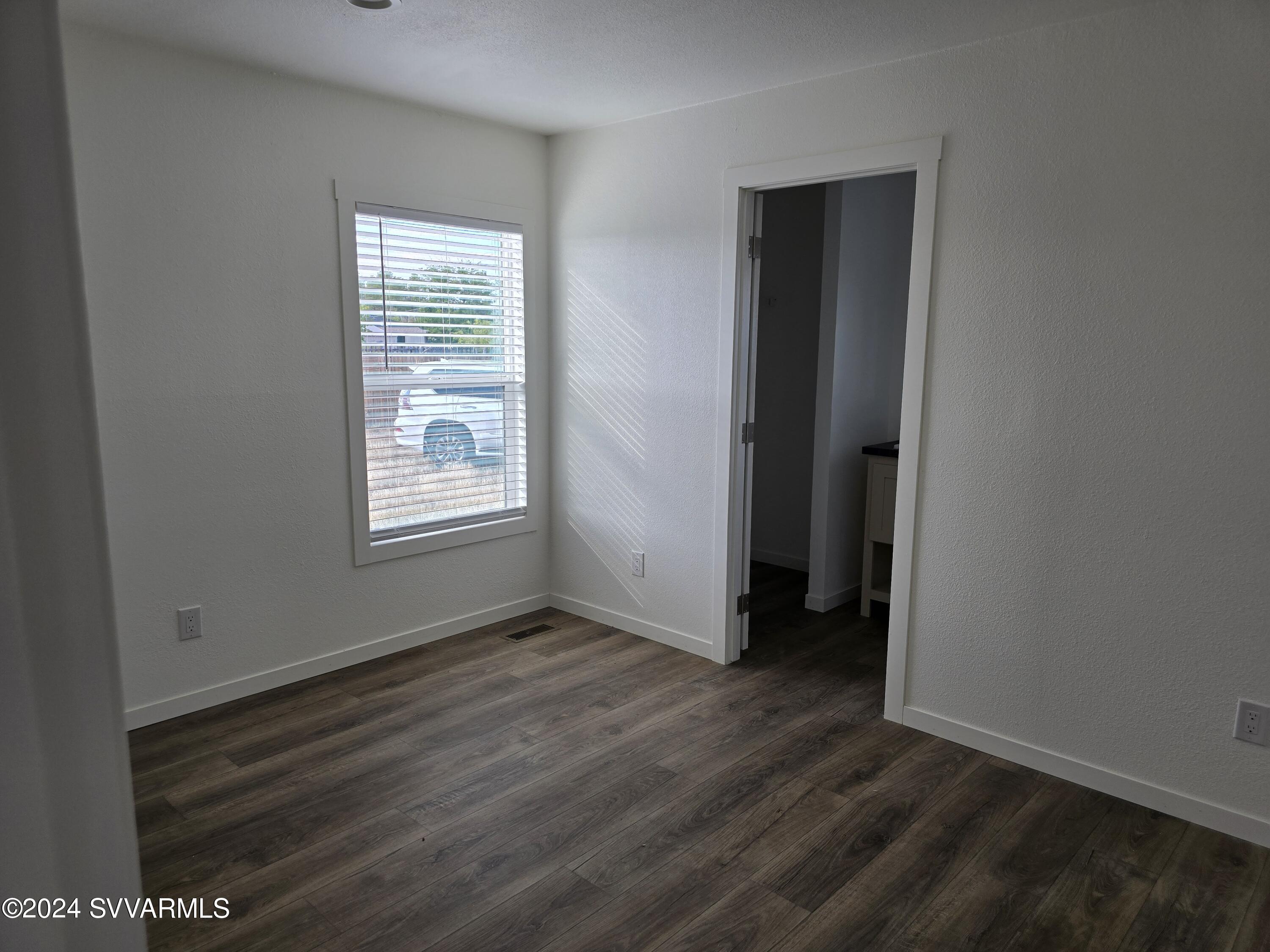 5205 Albatross Road Rimrock, AZ 86335 - Photo 15 of 23 an empty room with wooden floor and windows
