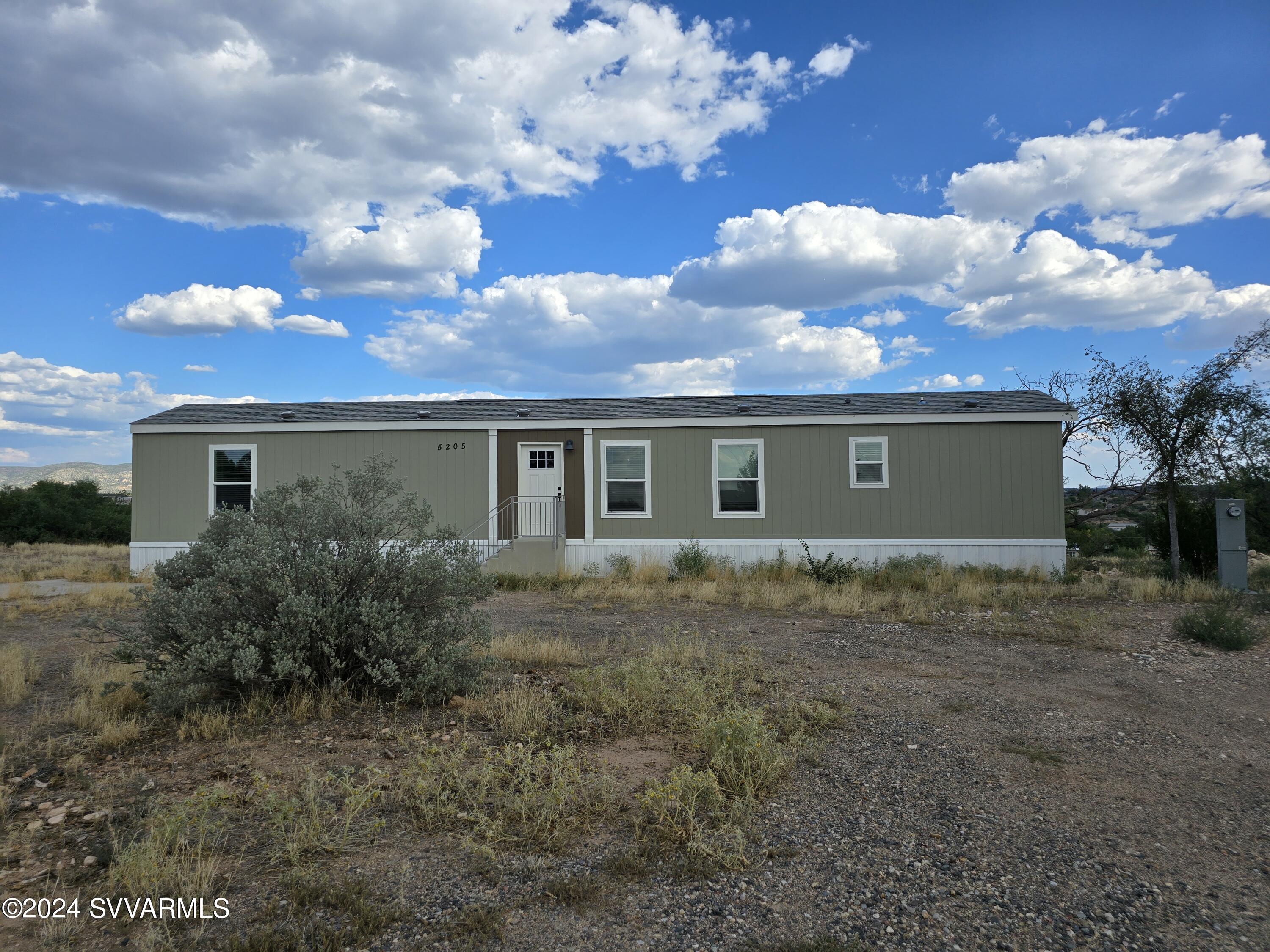 5205 Albatross Road Rimrock, AZ 86335 - Photo 2 of 23 front view of house with a yard