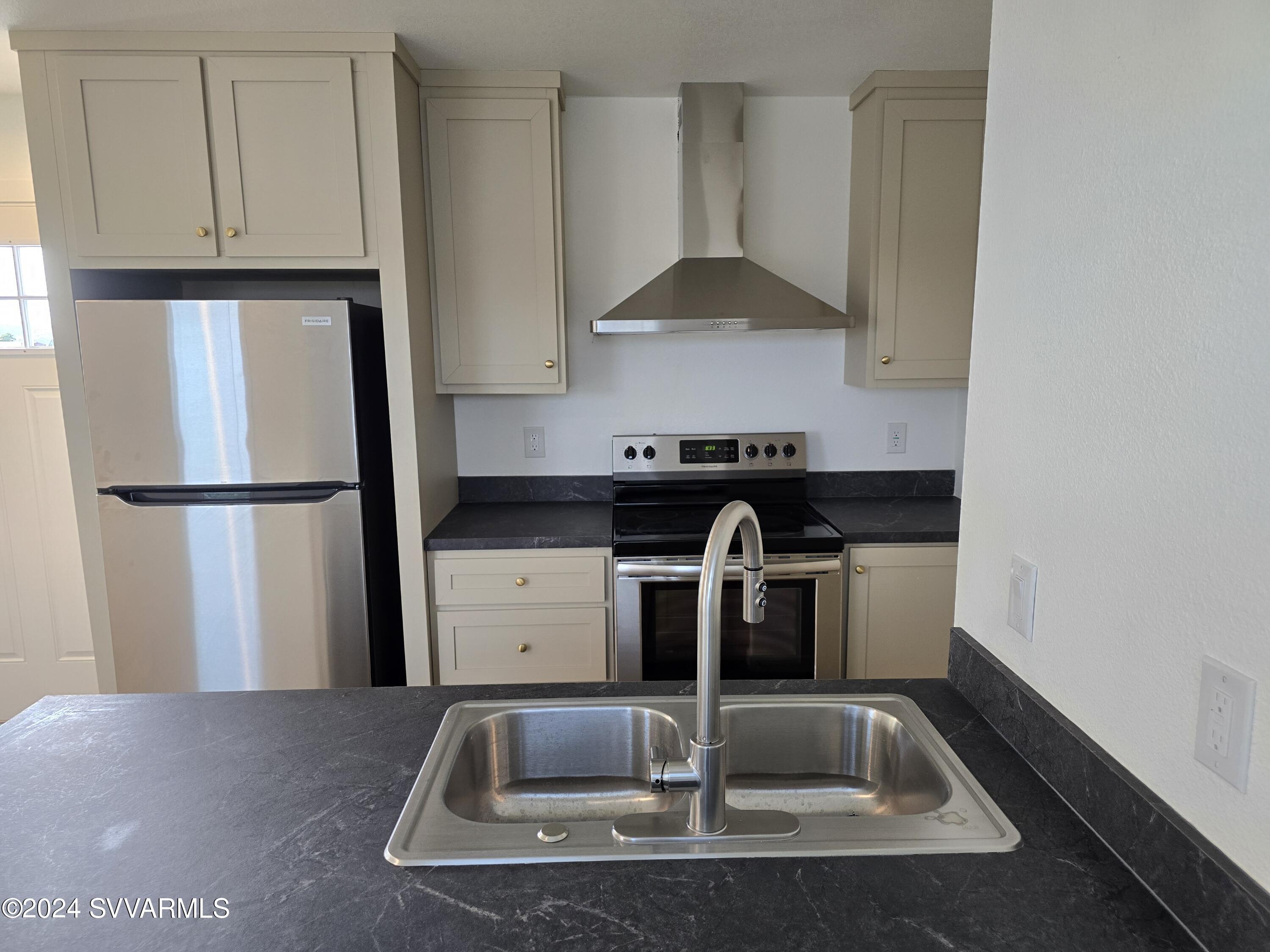 5205 Albatross Road Rimrock, AZ 86335 - Photo 10 of 23 a kitchen with a refrigerator and a sink