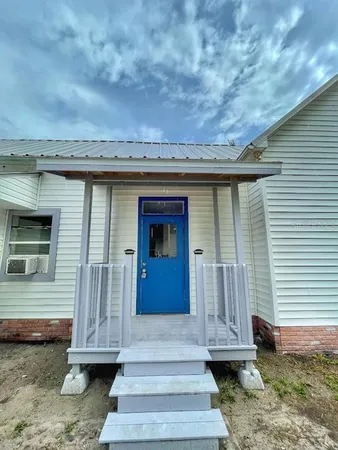 a view of a house with a door and a yard