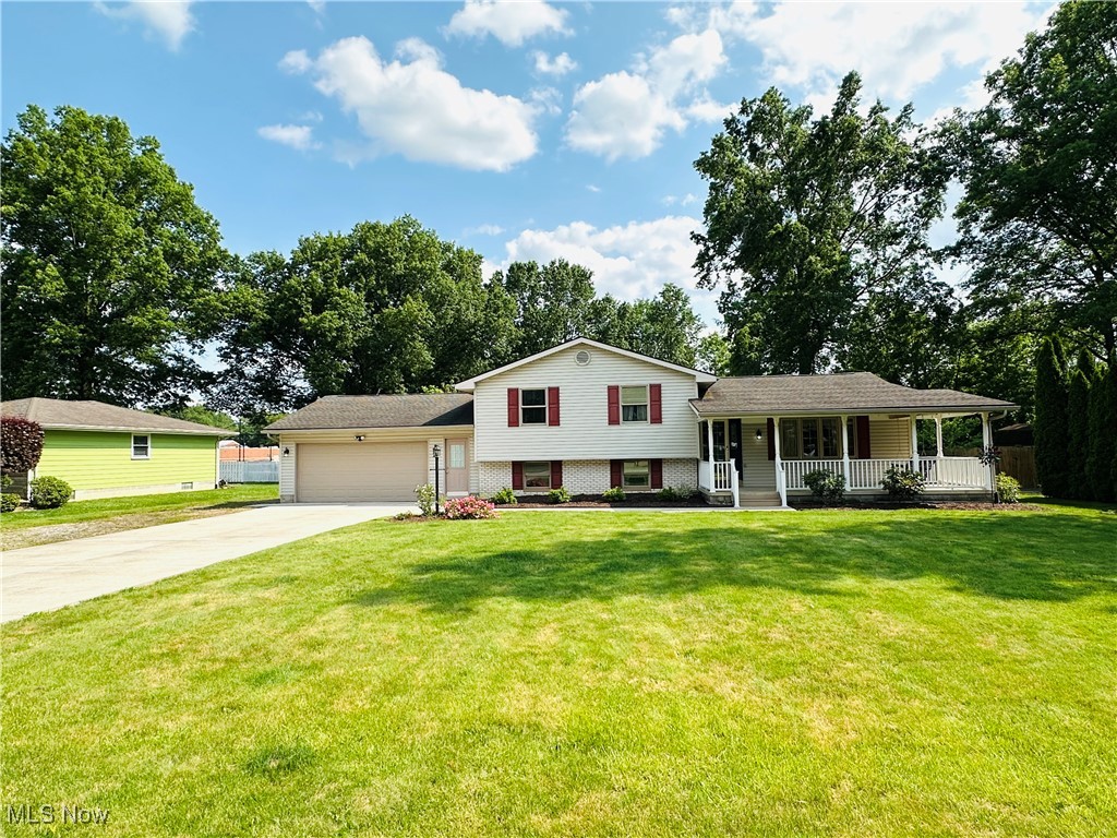 1684 Morris Street Mineral Ridge, OH 44440 - Photo 1 of 50 Tri-level home with concrete driveway, an attached garage, and covered porch