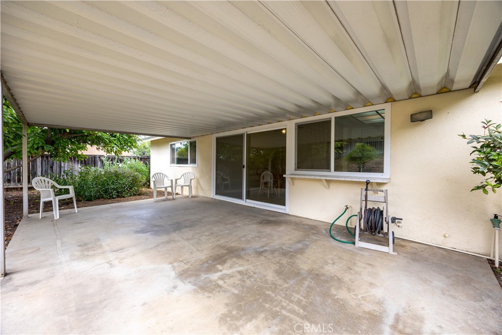 3430 Bahia Place Riverside, CA 92507 - Photo 28 of 34 a view of a patio with table and chairs potted plants with wooden fence