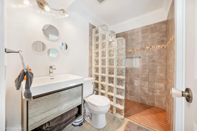 a bathroom with a sink toilet and shower