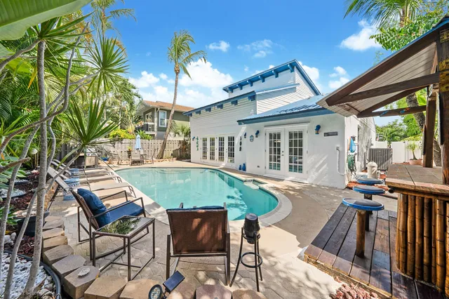 a view of a house with backyard and sitting area
