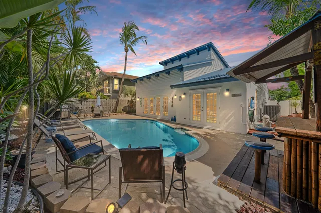 a backyard of a house with table and chairs