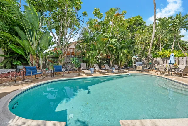 a swimming pool with outdoor seating and yard