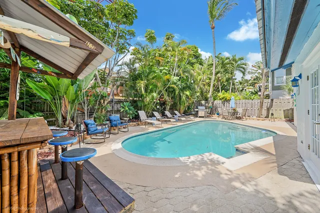 a view of swimming pool with outdoor seating and plants