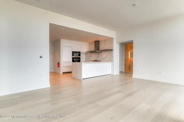 a living room with a large window and a flat screen tv
