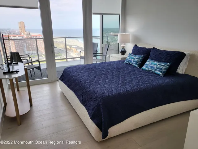 a large bed sitting in a bedroom next to a lamp