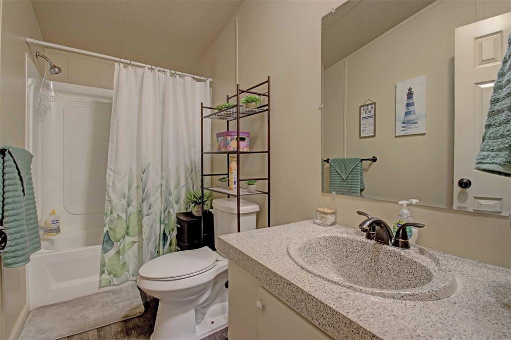 2004 Fall Creek Road Cleburne, TX 76033 - Photo 16 of 18 a bathroom with a sink toilet and shower
