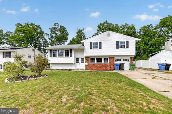 a view of a house with a yard and sitting area